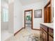 Main bathroom featuring tile floor, a glass block window, and a wooden-trimmed mirror at 4128 Whitetail Woods Dr, Bargersville, IN 46106