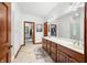 Main bathroom features double sinks, wooden cabinets, tile floor, and access to a walk-in closet at 4128 Whitetail Woods Dr, Bargersville, IN 46106