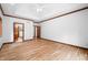 Bright main bedroom featuring hardwood floors, white walls, tray ceiling, and a ceiling fan at 4128 Whitetail Woods Dr, Bargersville, IN 46106