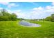 Expansive property featuring a serene pond, lush green lawns and landscaping, creating a peaceful environment at 4128 Whitetail Woods Dr, Bargersville, IN 46106