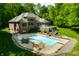 Expansive pool area with patio seating and a manicured lawn, perfect for outdoor relaxation and entertaining at 4128 Whitetail Woods Dr, Bargersville, IN 46106