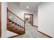 Carpeted stairs with wooden handrail and black metal spindles, leading to the finished basement at 4128 Whitetail Woods Dr, Bargersville, IN 46106