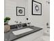 Modern bathroom featuring a gray countertop, white vanity, and decorative artwork at 4405 Mendocino Blvd, Indianapolis, IN 46239