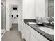 Modern bathroom featuring dual sinks, a sleek vanity, and a view into a spacious walk-in closet at 4405 Mendocino Blvd, Indianapolis, IN 46239
