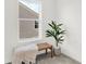 Bright bedroom featuring a bench with a throw blanket and a lush potted plant next to a window at 4405 Mendocino Blvd, Indianapolis, IN 46239