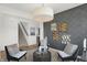 Cozy seating area with unique lighting, stylish decor, and staircase in the background at 4405 Mendocino Blvd, Indianapolis, IN 46239