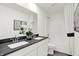 Elegant bathroom with double vanity, dark countertop, and white cabinetry at 4411 Mendocino Blvd, Indianapolis, IN 46239