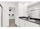 Modern bathroom with dual sinks, a large mirror, and view into walk-in closet at 4411 Mendocino Blvd, Indianapolis, IN 46239