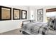 Cozy bedroom with three framed mirrors, window with view, and plaid bedding at 4411 Mendocino Blvd, Indianapolis, IN 46239