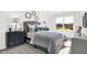 Charming bedroom with large windows, gray furniture, and decorative lamps at 4411 Mendocino Blvd, Indianapolis, IN 46239