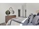 Bright bedroom featuring a dresser with round mirrors, neutral walls, and natural light at 4411 Mendocino Blvd, Indianapolis, IN 46239