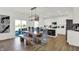 Kitchen with a bright dining area features a wood table with a bench, stainless steel appliances, and ample sunlight at 4411 Mendocino Blvd, Indianapolis, IN 46239