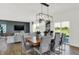 Bright dining area with wood table, modern lighting, and sliding glass doors leading to outdoor space at 4411 Mendocino Blvd, Indianapolis, IN 46239