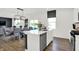 Bright, modern kitchen features stainless appliances, a central island, and a view into the dining area at 4411 Mendocino Blvd, Indianapolis, IN 46239