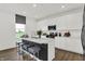 Modern kitchen with white cabinets, stainless steel appliances, and a quartz countertop island at 4411 Mendocino Blvd, Indianapolis, IN 46239
