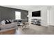 Modern living room featuring a gray sectional, wall-mounted TV, and ample seating at 4411 Mendocino Blvd, Indianapolis, IN 46239