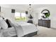 Bright main bedroom with black dresser, white bedding, and view of golf course at 4411 Mendocino Blvd, Indianapolis, IN 46239