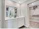 Bright bathroom showcasing a double sink vanity with modern fixtures and a view of the walk-in closet at 4518 Laughter Ln, Indianapolis, IN 46235