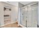 Modern bathroom with glass enclosed shower and large walk-in closet with white wire shelving at 4518 Laughter Ln, Indianapolis, IN 46235