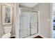 Modern bathroom featuring a glass shower with silver trim, white toilet, and neutral paint at 4518 Laughter Ln, Indianapolis, IN 46235
