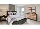 Inviting bedroom with a classic bed frame, wooden dresser, and ample natural light at 4518 Laughter Ln, Indianapolis, IN 46235