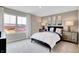 Sunlit bedroom with large window, plush carpet, and neutral tones for a relaxing atmosphere at 4518 Laughter Ln, Indianapolis, IN 46235