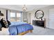 Bright bedroom showcasing a large bed, a round mirror and modern furniture, creating a comfortable and stylish atmosphere at 4518 Laughter Ln, Indianapolis, IN 46235