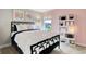 Cozy bedroom with stylish black bed frame, large window and charming decor at 4518 Laughter Ln, Indianapolis, IN 46235
