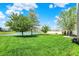 Beautiful backyard with a pond view, mature trees, and a well-maintained lawn at 4602 Amesbury Pl, Westfield, IN 46062