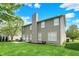 Spacious green backyard featuring a patio, mature trees, and manicured landscaping at 4602 Amesbury Pl, Westfield, IN 46062
