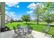 Scenic backyard featuring an outdoor table and chairs with a view of a well-maintained lawn at 4602 Amesbury Pl, Westfield, IN 46062