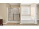 This bathroom features a soaking tub and glass door shower at 4602 Amesbury Pl, Westfield, IN 46062