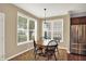 The dining area is well-lit with large windows and a wooden table, creating an ideal Gathering dining at 4602 Amesbury Pl, Westfield, IN 46062