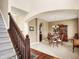 Open dining room featuring a chandelier and hardwood floors, seamlessly connecting to the staircase and kitchen at 4602 Amesbury Pl, Westfield, IN 46062