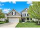 Charming two-story home with stone accents, well-maintained lawn, and inviting front porch at 4602 Amesbury Pl, Westfield, IN 46062