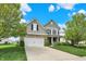 Traditional two-story home with stone accents, attached garage, and well-maintained landscaping at 4602 Amesbury Pl, Westfield, IN 46062