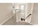 Bright two-story foyer featuring carpeted stairs and a view of the front door at 4602 Amesbury Pl, Westfield, IN 46062