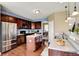 Modern kitchen with stainless steel appliances, dark cabinets, and center island at 4602 Amesbury Pl, Westfield, IN 46062
