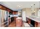 The kitchen features wooden cabinetry, black appliances and kitchen island for functionality and convenience at 4602 Amesbury Pl, Westfield, IN 46062