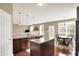 A modern kitchen with a center island and views to an adjacent dining area, perfect for Gathering moments at 4602 Amesbury Pl, Westfield, IN 46062