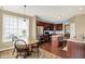 A warm kitchen featuring wooden cabinets, stainless steel appliances, and an adjacent dining area at 4602 Amesbury Pl, Westfield, IN 46062