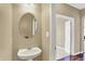 Charming powder room with a pedestal sink, neutral walls, and easy access to the hallway at 4602 Amesbury Pl, Westfield, IN 46062