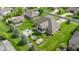 Aerial view of the backyard featuring a hot tub, outdoor living space, lush greenery, and mature trees at 4890 Benthaven E Dr, Bargersville, IN 46106