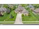 Aerial view of a beautiful home with manicured lawn and landscaping in a suburban neighborhood at 4890 Benthaven E Dr, Bargersville, IN 46106
