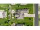 An overhead view showing an expansive roof, a hot tub, driveway, and lush green surroundings at 4890 Benthaven E Dr, Bargersville, IN 46106