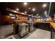 Custom basement bar features stainless steel appliances and an adjacent staircase at 4890 Benthaven E Dr, Bargersville, IN 46106