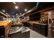 Basement bar with custom wood countertop, stainless appliances, and cabinet storage at 4890 Benthaven E Dr, Bargersville, IN 46106