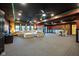 A spacious basement area featuring a large sectional sofa, entertainment area, and a dining table at 4890 Benthaven E Dr, Bargersville, IN 46106