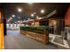 Expansive finished basement with a wooden bar, stainless fridge, and seating area at 4890 Benthaven E Dr, Bargersville, IN 46106