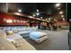 Basement area features a large sectional sofa, a bar with stools, and accent lighting at 4890 Benthaven E Dr, Bargersville, IN 46106